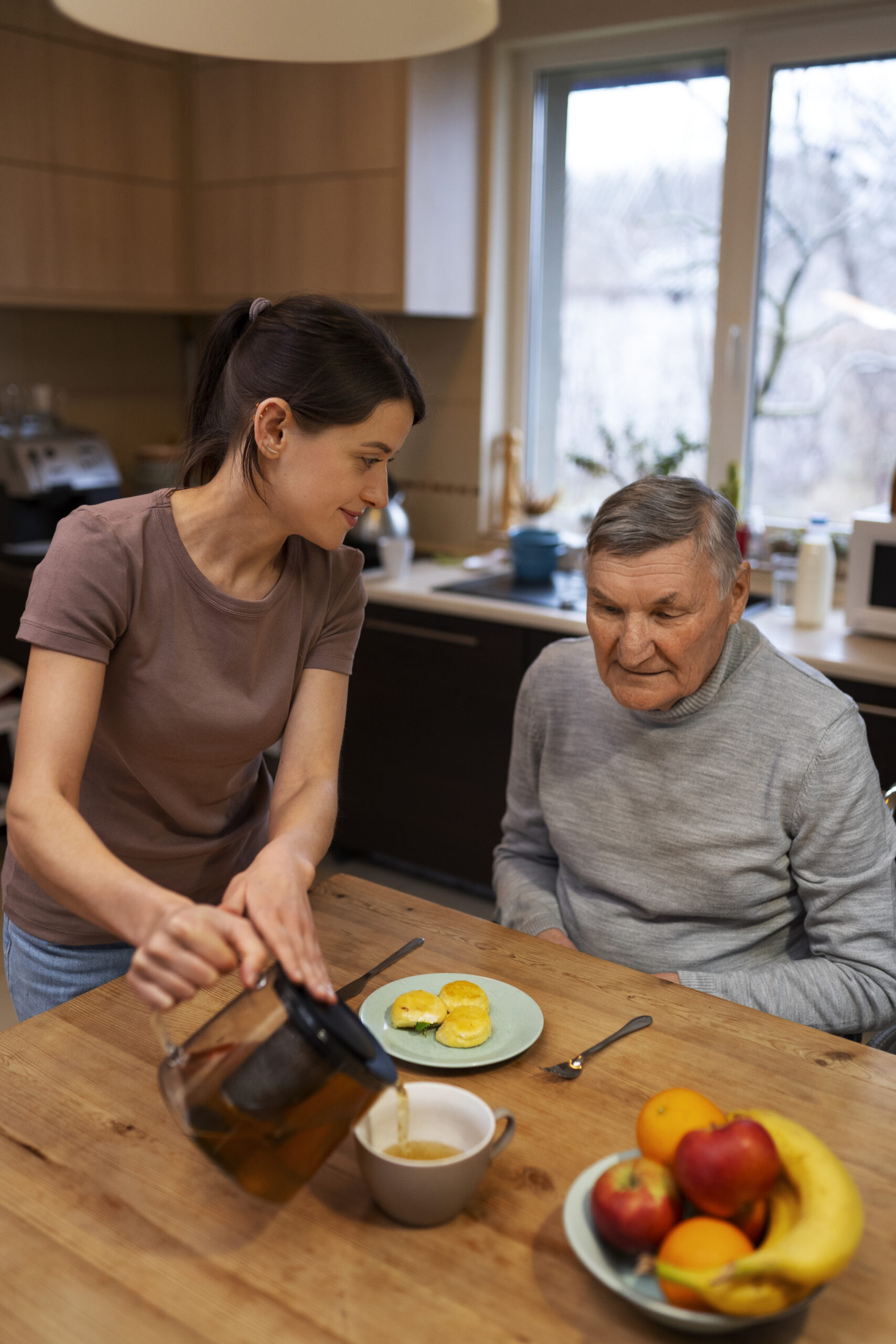 female caretaker with client home doing her job scaled